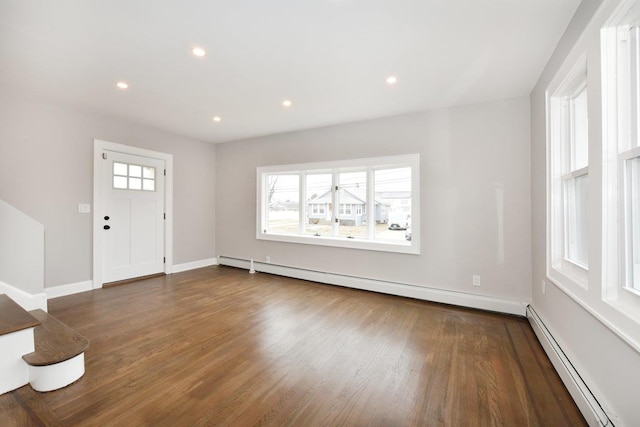 foyer featuring recessed lighting, wood finished floors, a baseboard heating unit, and a baseboard radiator