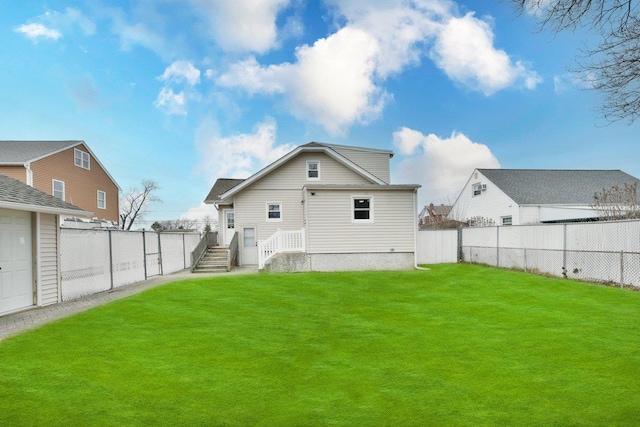 back of property with a lawn and a fenced backyard