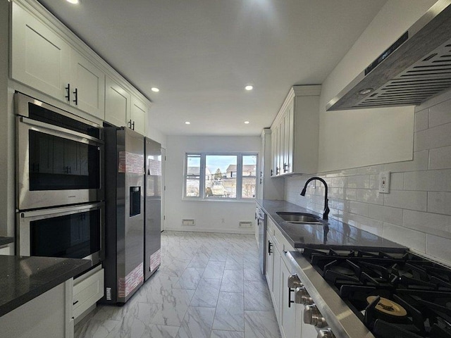 kitchen featuring marble finish floor, a sink, white cabinetry, stainless steel appliances, and extractor fan