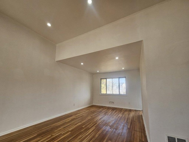 spare room featuring recessed lighting, visible vents, baseboards, and dark wood-type flooring