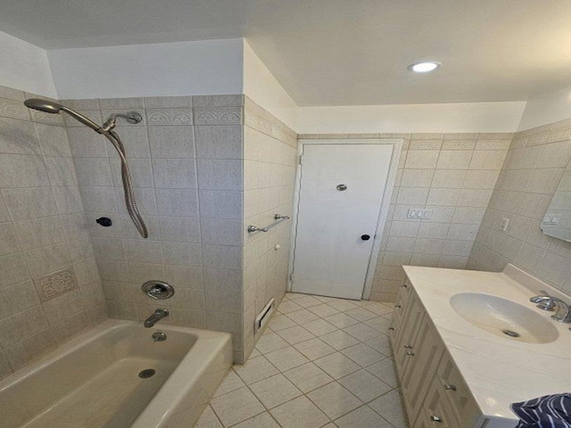 bathroom featuring tile patterned flooring, tile walls, bathing tub / shower combination, and vanity