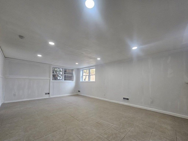 basement featuring recessed lighting and visible vents