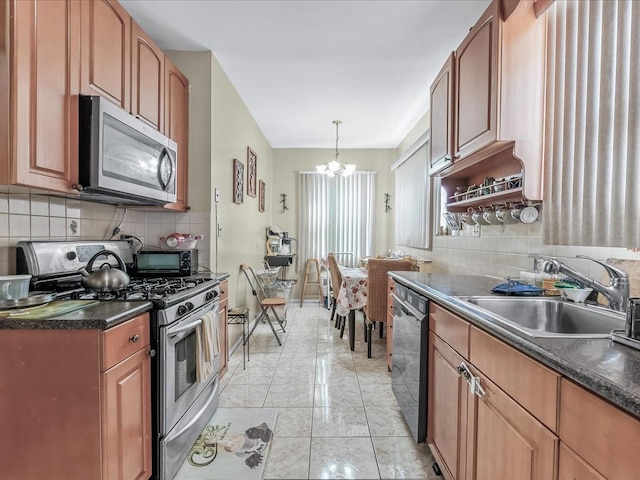 142-02 185th St, Springfield Gardens, NY 11413 - kitchen featuring dark countertops, decorative backsplash, appliances with stainless steel finishes, a notable chandelier, and a sink