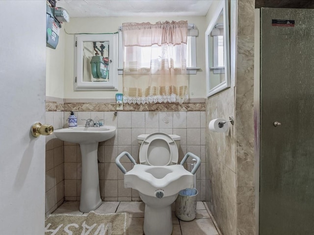 142-02 185th St, Springfield Gardens, NY 11413 - bathroom with tile patterned floors, toilet, tile walls, and a wainscoted wall