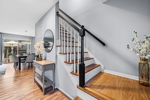 stairway with baseboards and wood finished floors