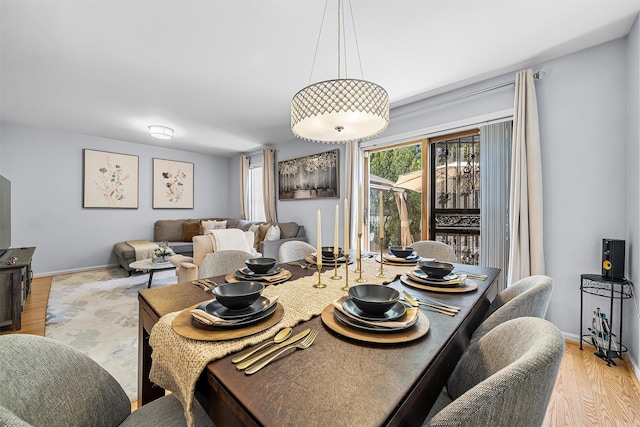 dining room featuring baseboards and wood finished floors