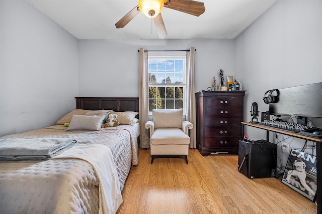 bedroom with a ceiling fan and light wood-type flooring