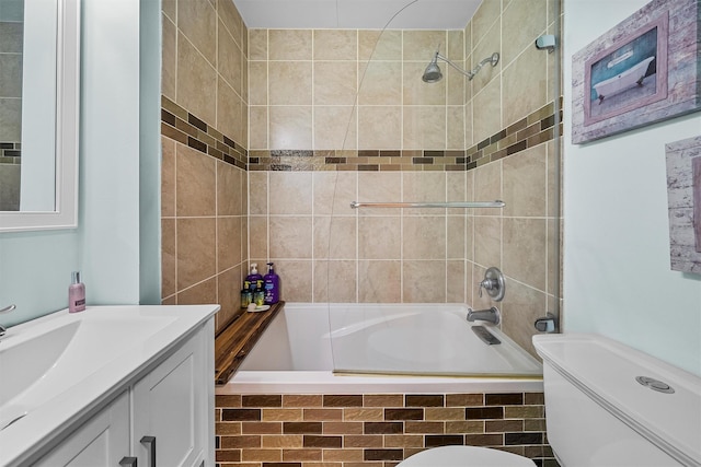 full bathroom with tiled shower / bath combo, toilet, and vanity