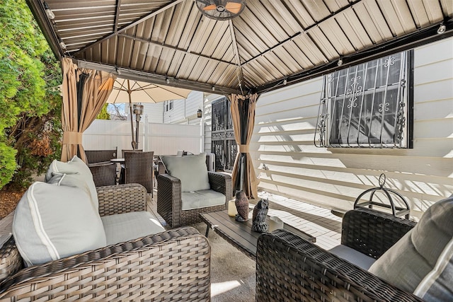 view of patio / terrace featuring a gazebo, an outdoor hangout area, and fence