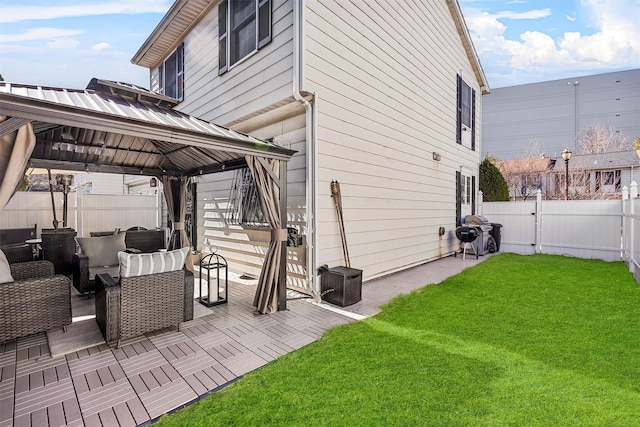 view of side of property with a gazebo, a yard, and a fenced backyard