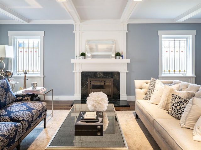 living room featuring a fireplace, beam ceiling, wood finished floors, and baseboards