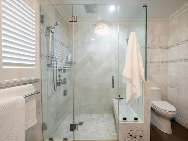 full bathroom with a shower stall, toilet, and ornamental molding