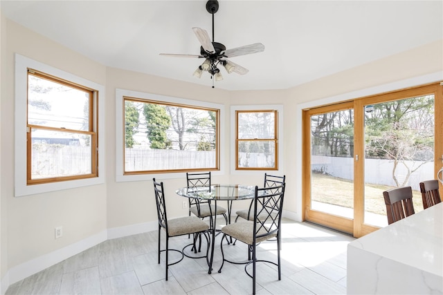 dining area with baseboards and a ceiling fan