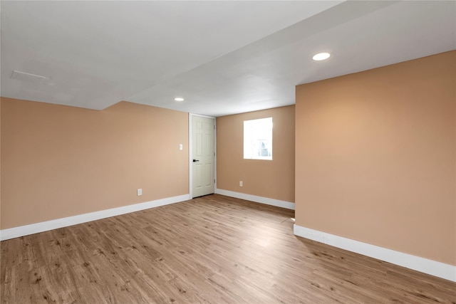 spare room with recessed lighting, light wood-type flooring, and baseboards