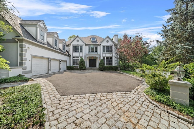 2 Camden Ct, Irvington, NY 10533 - view of front of property featuring stucco siding, driveway, and a garage