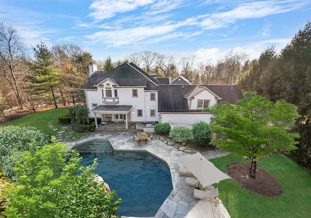 2 Camden Ct, Irvington, NY 10533 - rear view of property with a chimney, a patio area, stucco siding, and a yard