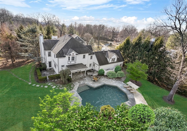 2 Camden Ct, Irvington, NY 10533 - rear view of property with a lawn, a patio area, a chimney, an outdoor pool, and stucco siding