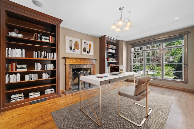 2 Camden Ct, Irvington, NY 10533 - office space featuring a high end fireplace, a chandelier, and light wood-style floors