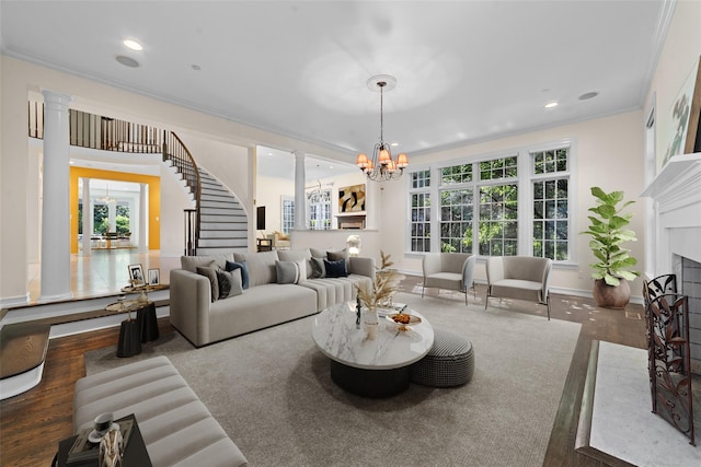 2 Camden Ct, Irvington, NY 10533 - living room featuring stairs, a chandelier, ornamental molding, wood finished floors, and a fireplace