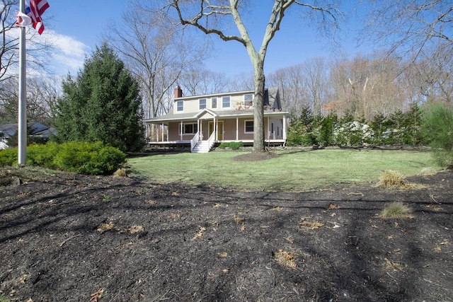 farmhouse-style home with a porch, a chimney, and a front lawn