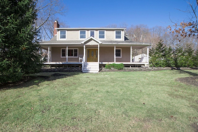 country-style home featuring a chimney, covered porch, and a front lawn