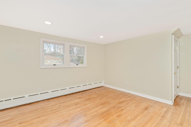 unfurnished room with recessed lighting, baseboards, light wood-style floors, and a baseboard radiator