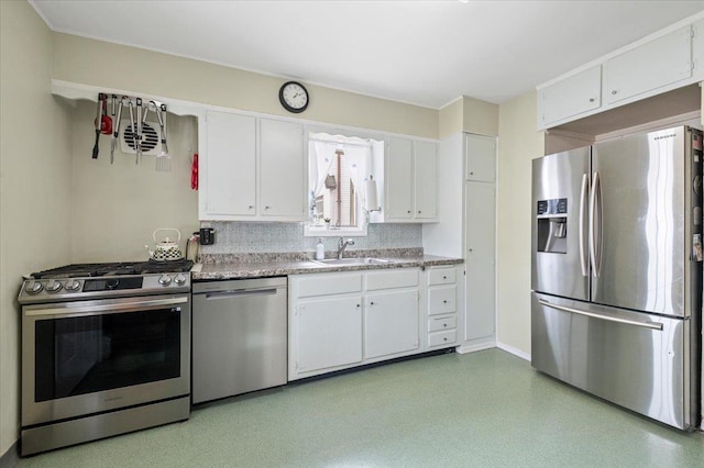 kitchen featuring a sink, stainless steel appliances, white cabinets, and light countertops