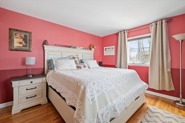 bedroom featuring wood finished floors and baseboards