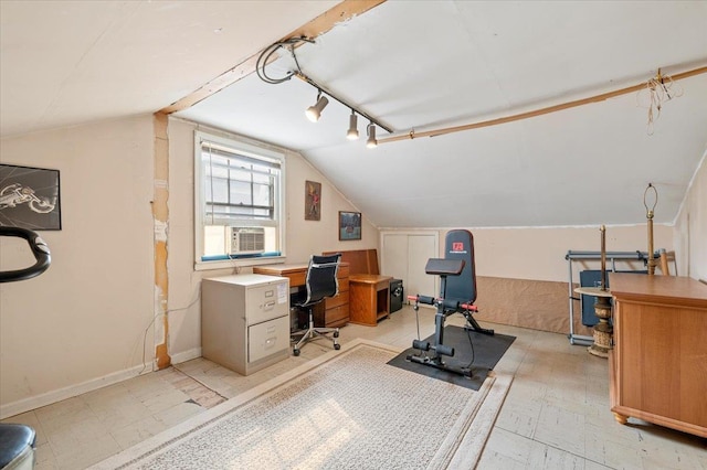 office space featuring track lighting, baseboards, light floors, vaulted ceiling, and cooling unit