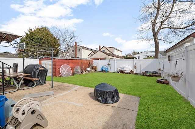 view of yard featuring a patio, a fenced backyard, and an outbuilding