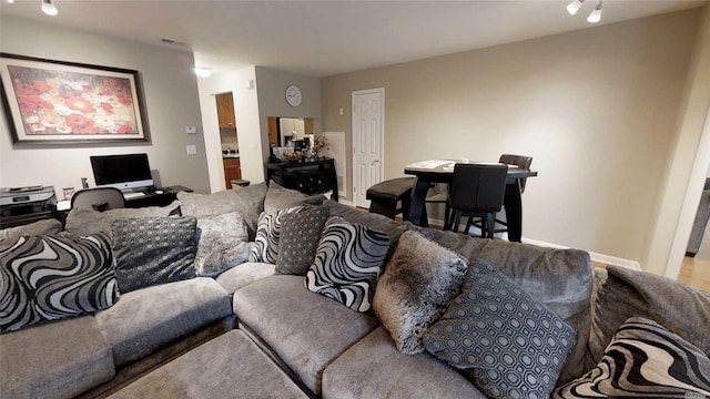 living area featuring baseboards