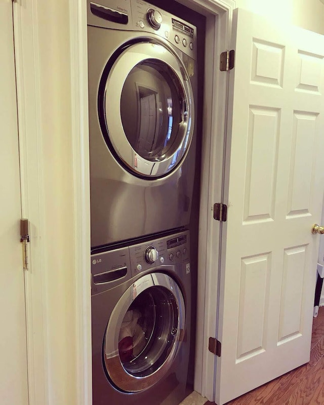 clothes washing area with laundry area and stacked washer / dryer