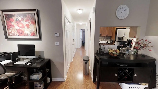 office featuring baseboards and light wood-style floors