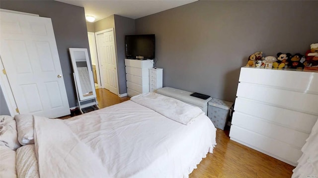 bedroom featuring wood finished floors and a closet