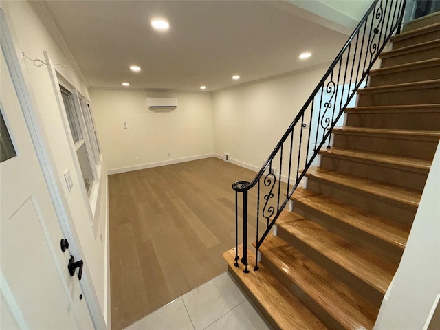 stairs featuring crown molding, baseboards, an AC wall unit, recessed lighting, and wood finished floors