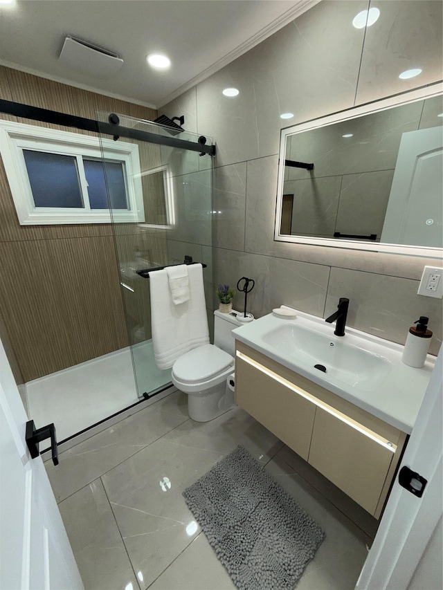 bathroom with a shower stall, tile walls, vanity, and toilet