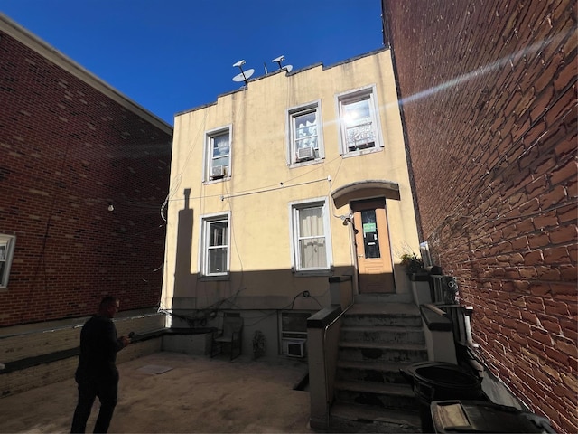 view of front facade featuring stucco siding and a patio