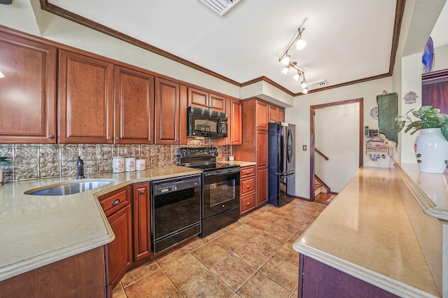 kitchen featuring visible vents, backsplash, light countertops, black appliances, and a sink