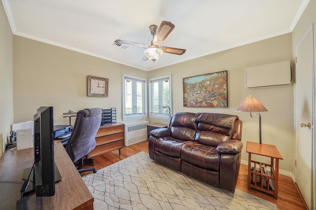 home office featuring ceiling fan, crown molding, radiator heating unit, and light wood-style floors