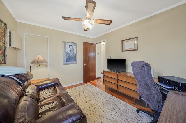 office area featuring ceiling fan, wood finished floors, baseboards, and ornamental molding