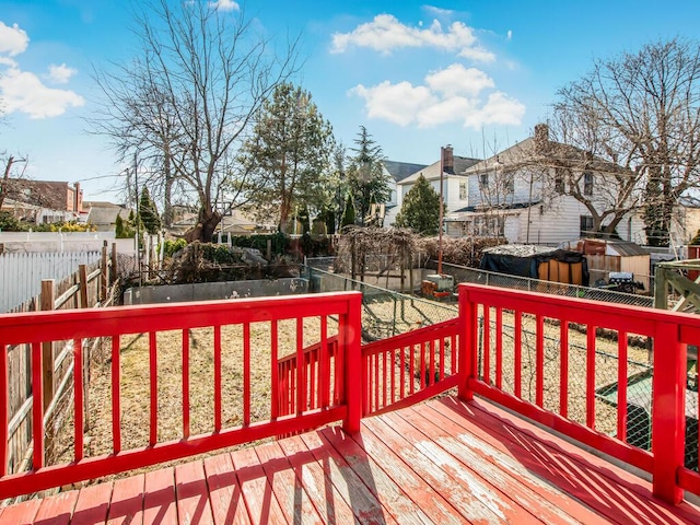 deck with a yard, a fenced backyard, and a residential view