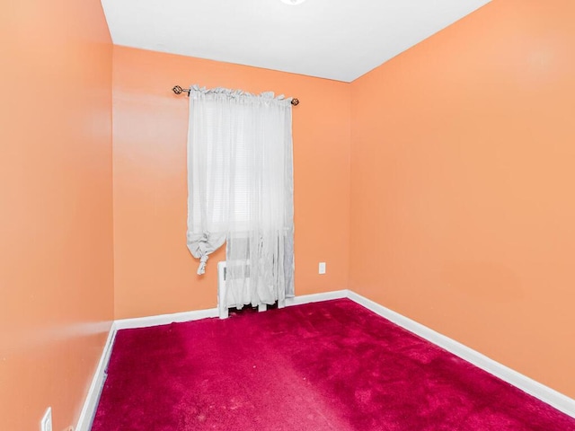 carpeted spare room with baseboards