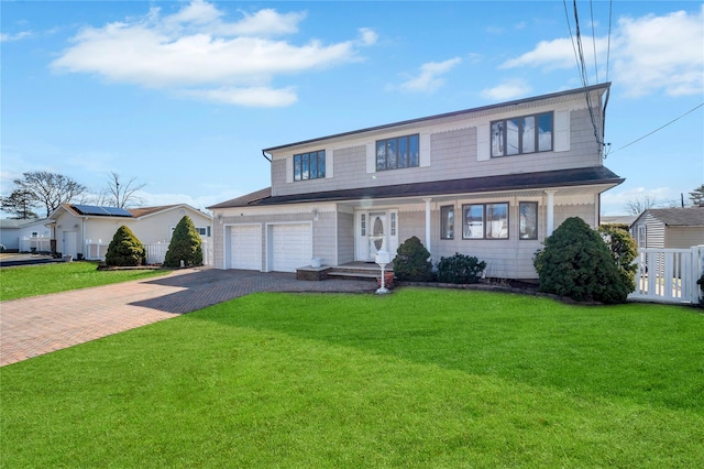 view of front of house with decorative driveway and a front yard