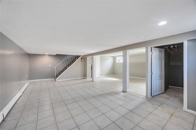 below grade area featuring a baseboard heating unit, recessed lighting, light tile patterned floors, baseboards, and stairs