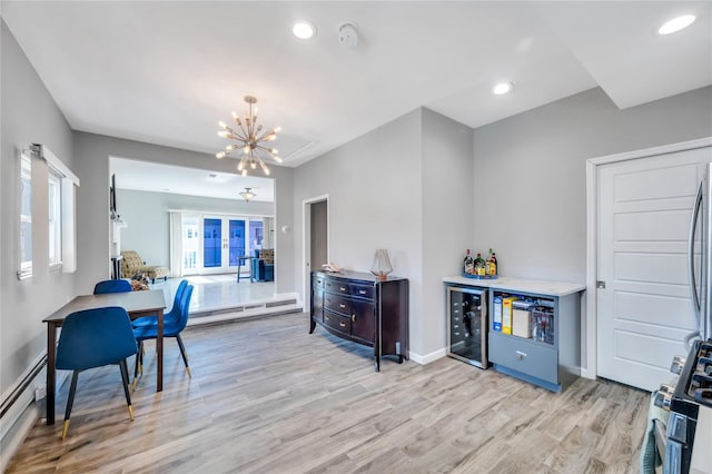 kitchen featuring light wood-type flooring, a baseboard heating unit, wine cooler, and recessed lighting