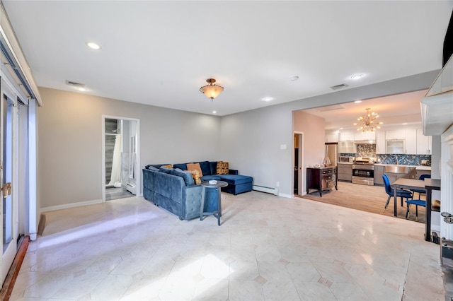 living area with a chandelier, baseboard heating, baseboards, and visible vents