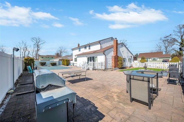 view of patio with grilling area, outdoor dining area, and a fenced backyard