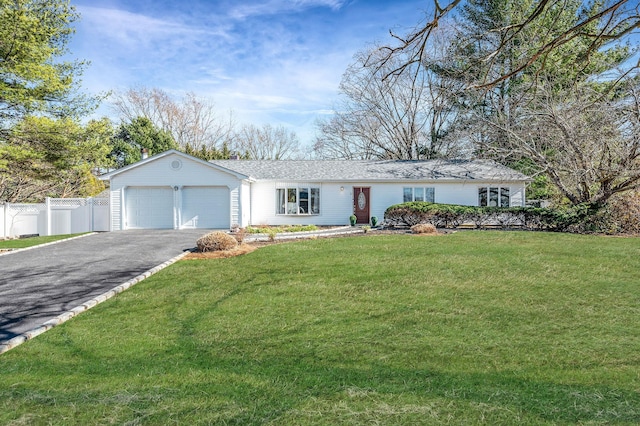 single story home featuring a front lawn, fence, a garage, and driveway