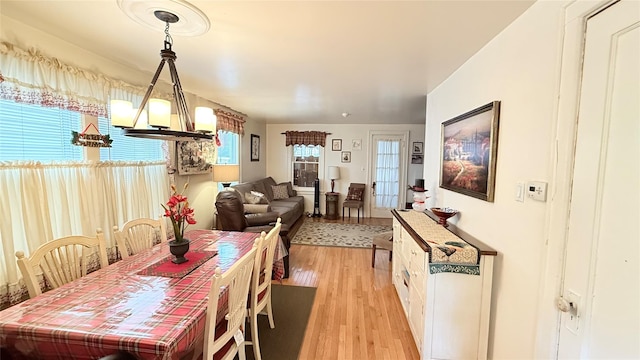 dining room with an inviting chandelier and light wood-style flooring