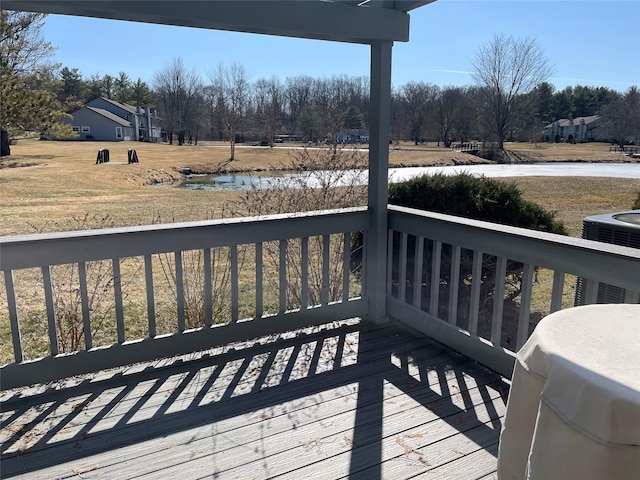 deck featuring central air condition unit and a water view